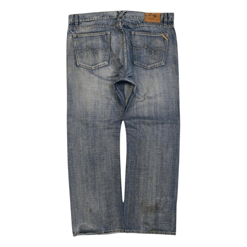 Back view of a pair of blue denim jeans with a faded wash, showing the back pockets and a small brown leather brand patch near the waistband.