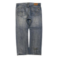 Back view of a pair of blue denim jeans with a faded wash, showing the back pockets and a small brown leather brand patch near the waistband.