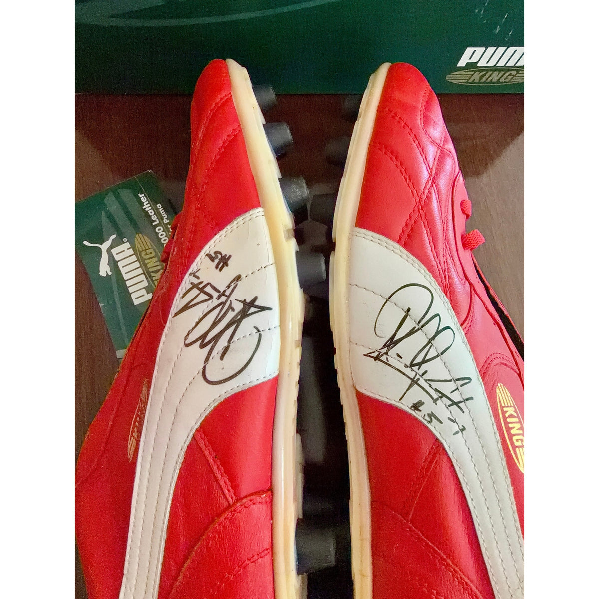Vintage Puma King OG football boots in red/white, signed on both boots.