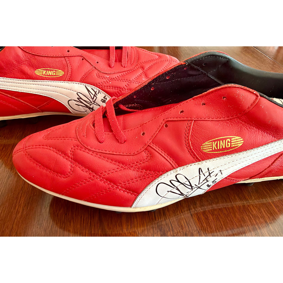 Vintage Puma King OG football boots in red/white, signed on both boots.